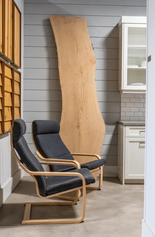 Large wood slab with 2 chairs in office showroom